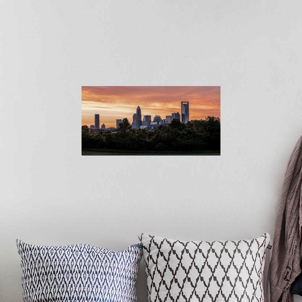 A bohemian room featuring The sun setting on the largest city in North Carolina.