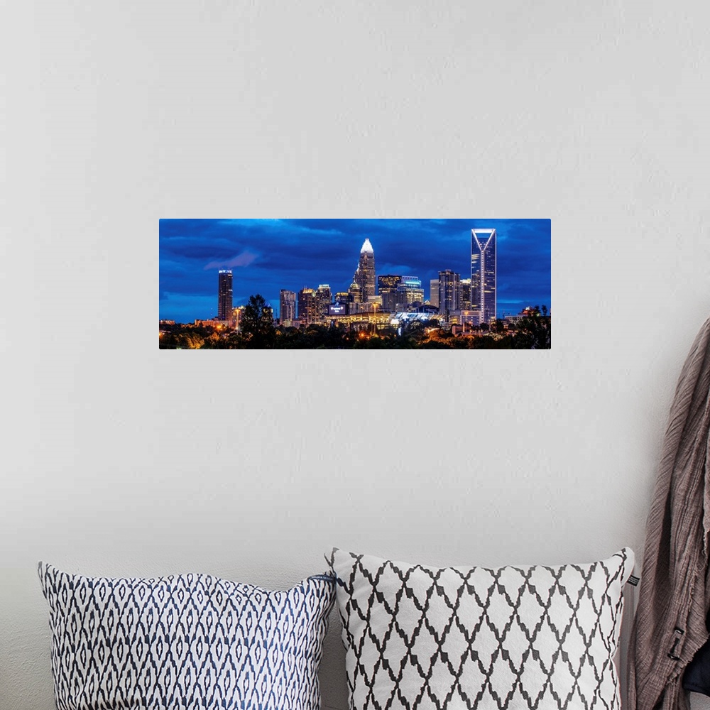 A bohemian room featuring Horizontal image of Charlotte, North Carolina at night with clouds in the sky.