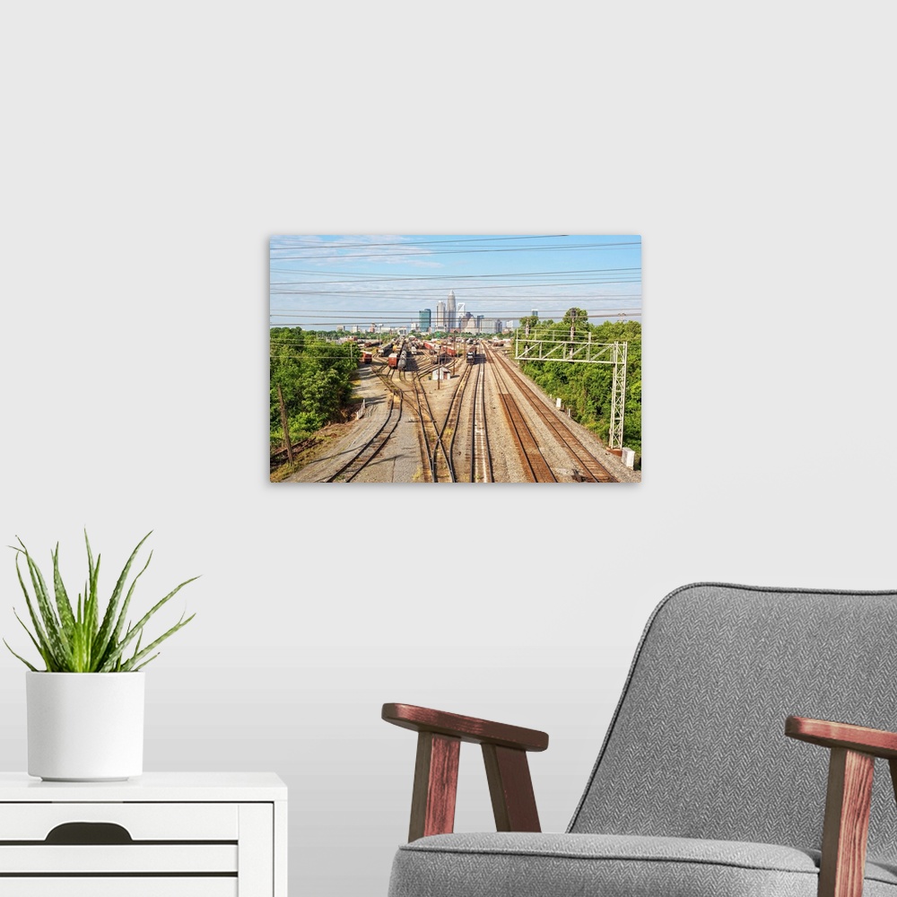 A modern room featuring A freight train leaving the city of Charlotte, North Carolina.