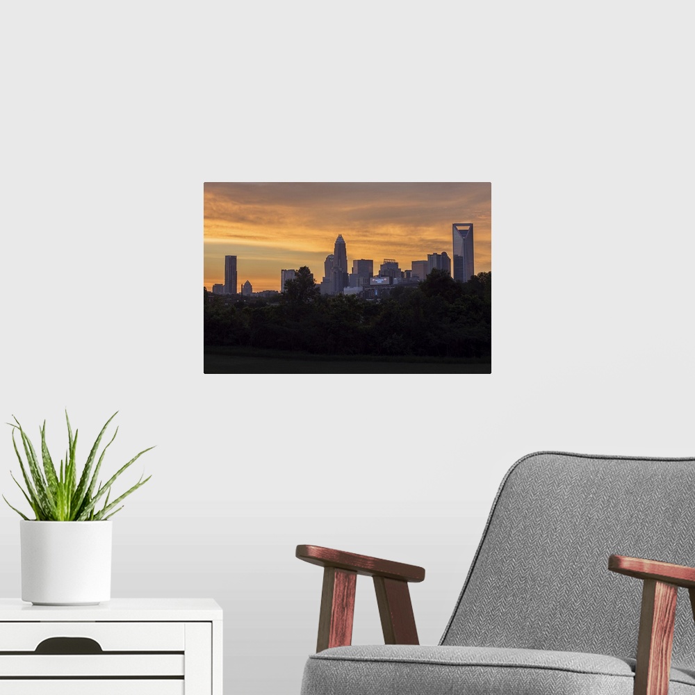 A modern room featuring The sun rising on the largest city in North Carolina.
