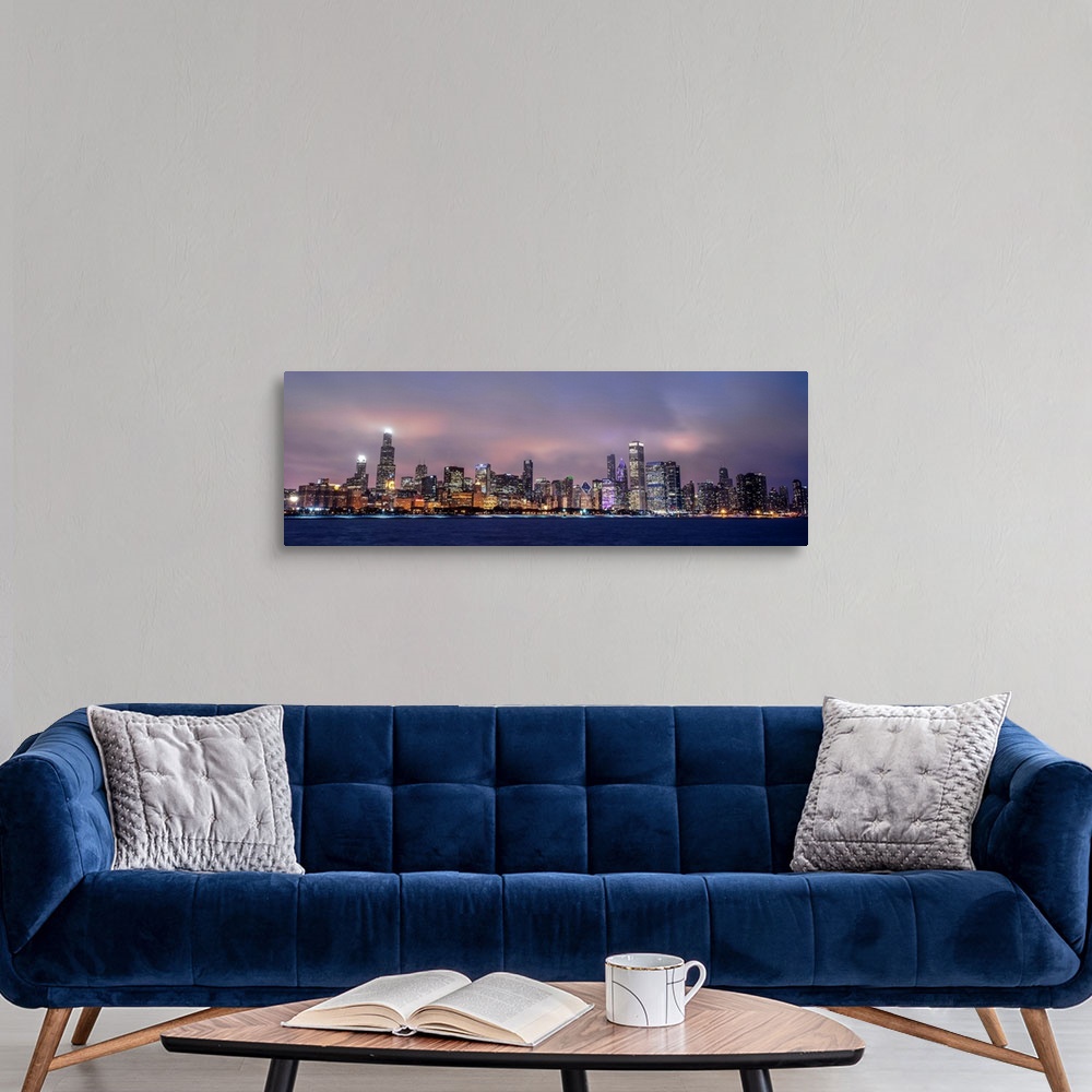 A modern room featuring Panoramic view of the Chicago city skyline in the early evening, with city lights reflecting off ...