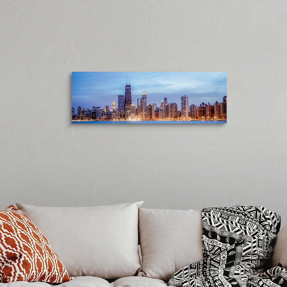 A bohemian room featuring Panoramic view of the Chicago city skyline illuminated in the early evening, seen from the edge o...
