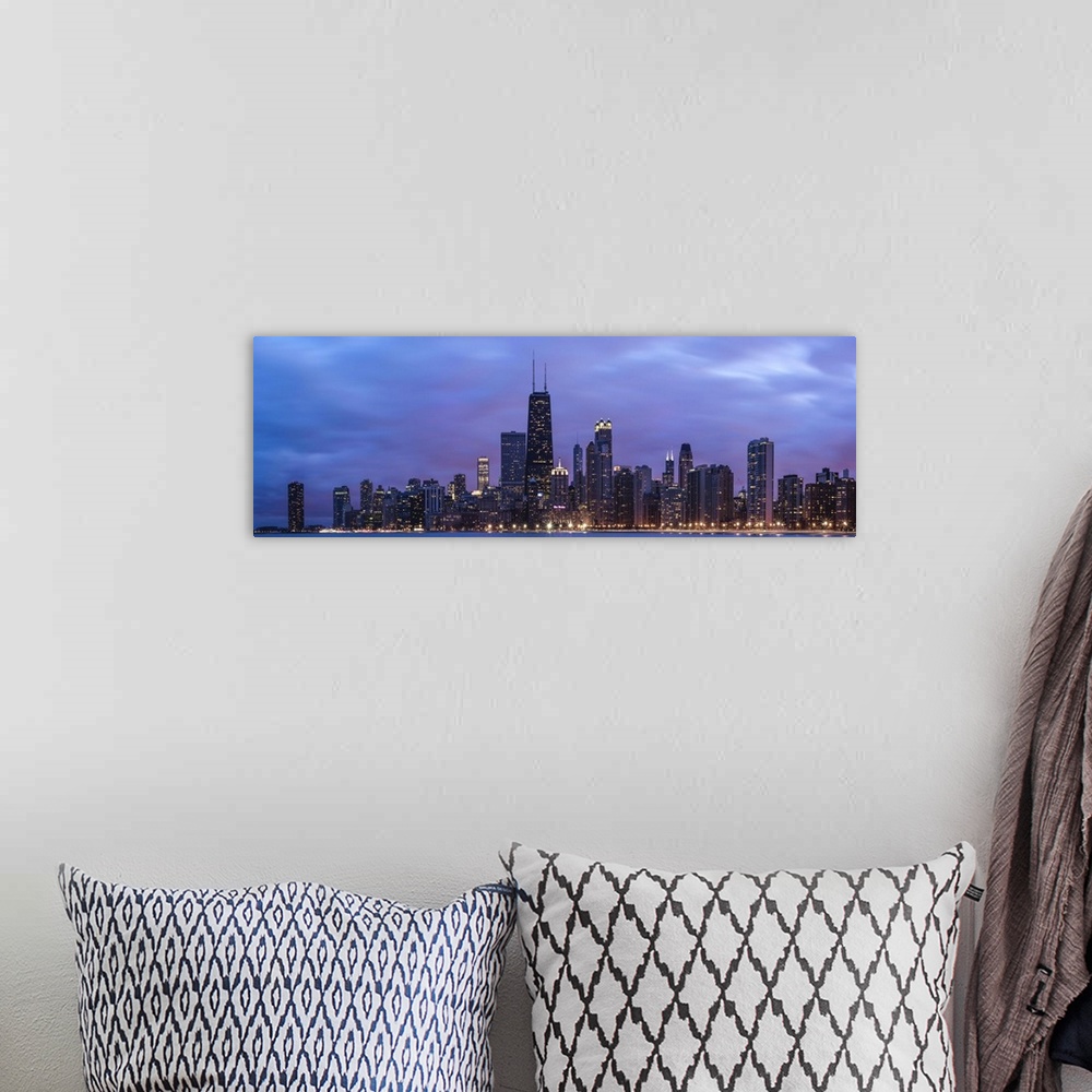 A bohemian room featuring Panoramic view of the Chicago city skyline illuminated in the early evening, seen from across the...