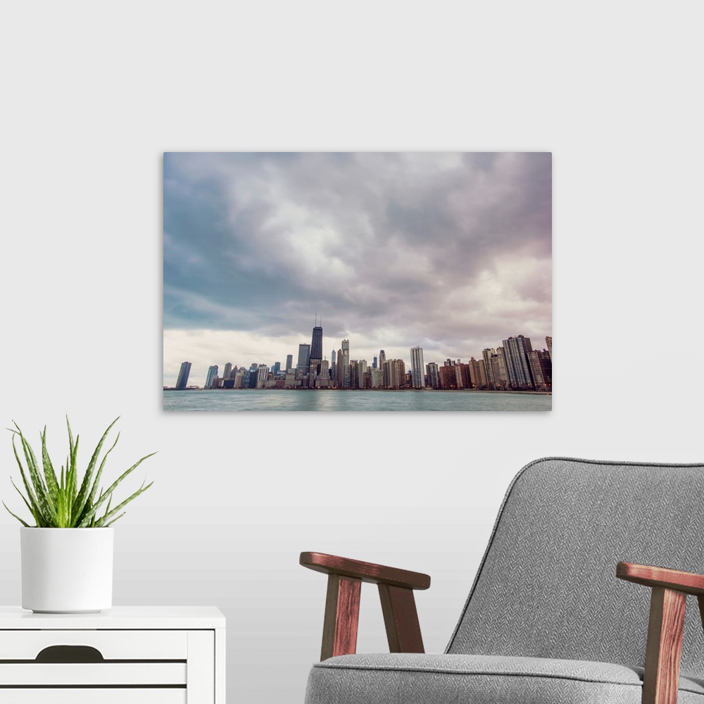 A modern room featuring Photo of Chicago's skyline under dramatic clouds.