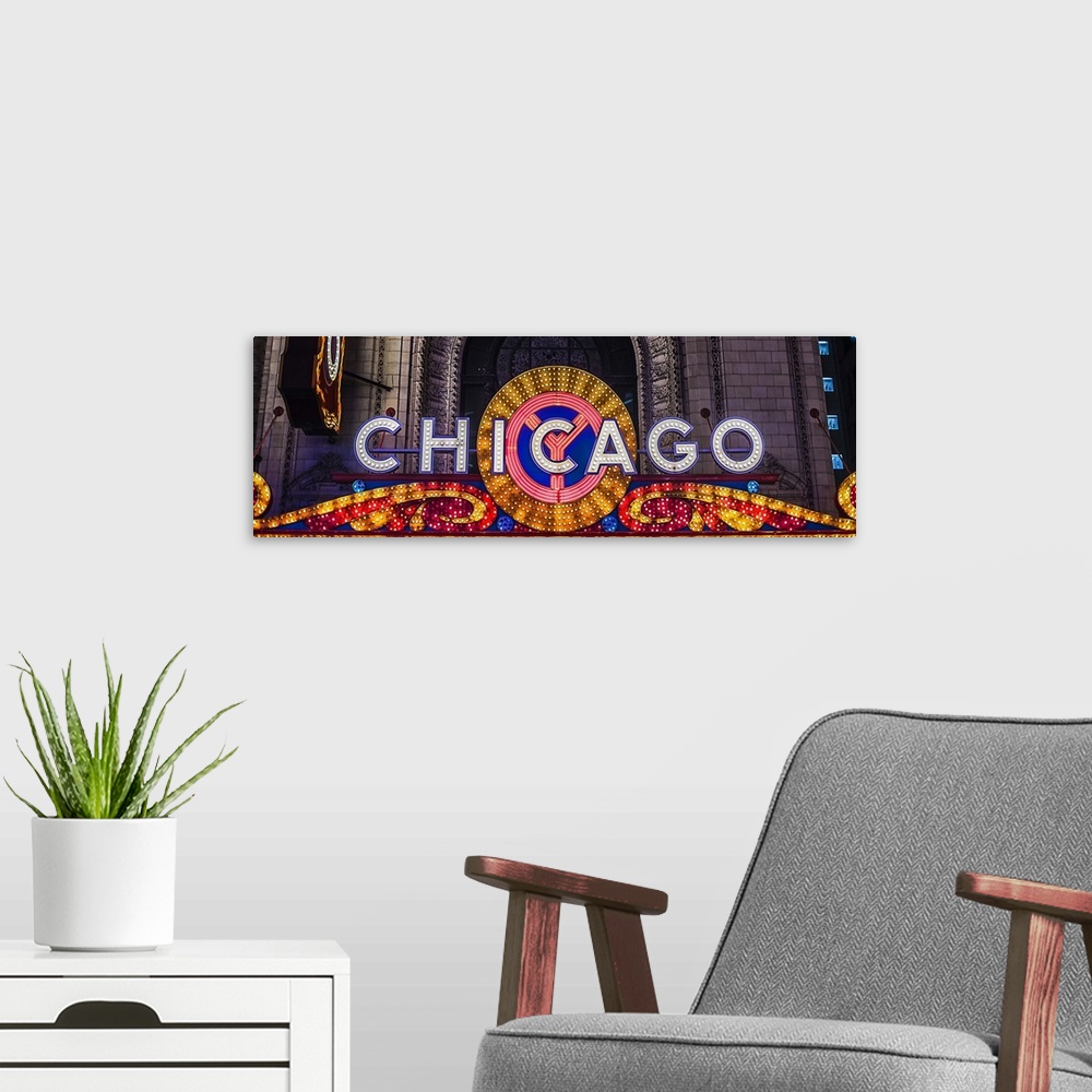 A modern room featuring Panoramic image of the Chicago Theater Marquee with glowing lights in the evening.