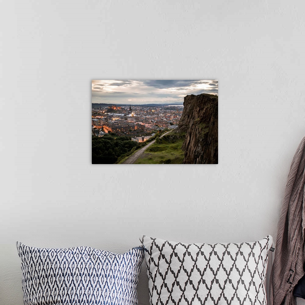 A bohemian room featuring Photograph of the city of Edinburgh, Scotland lit up at sunset with a view from Holyrood Park.