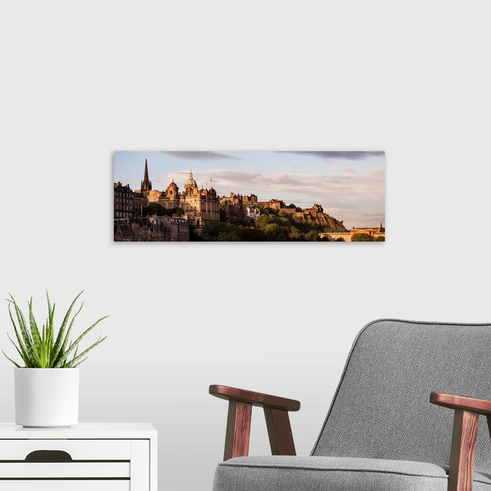 A modern room featuring Panoramic photograph of part of the city of Edinburgh with the castle in the background, at golde...