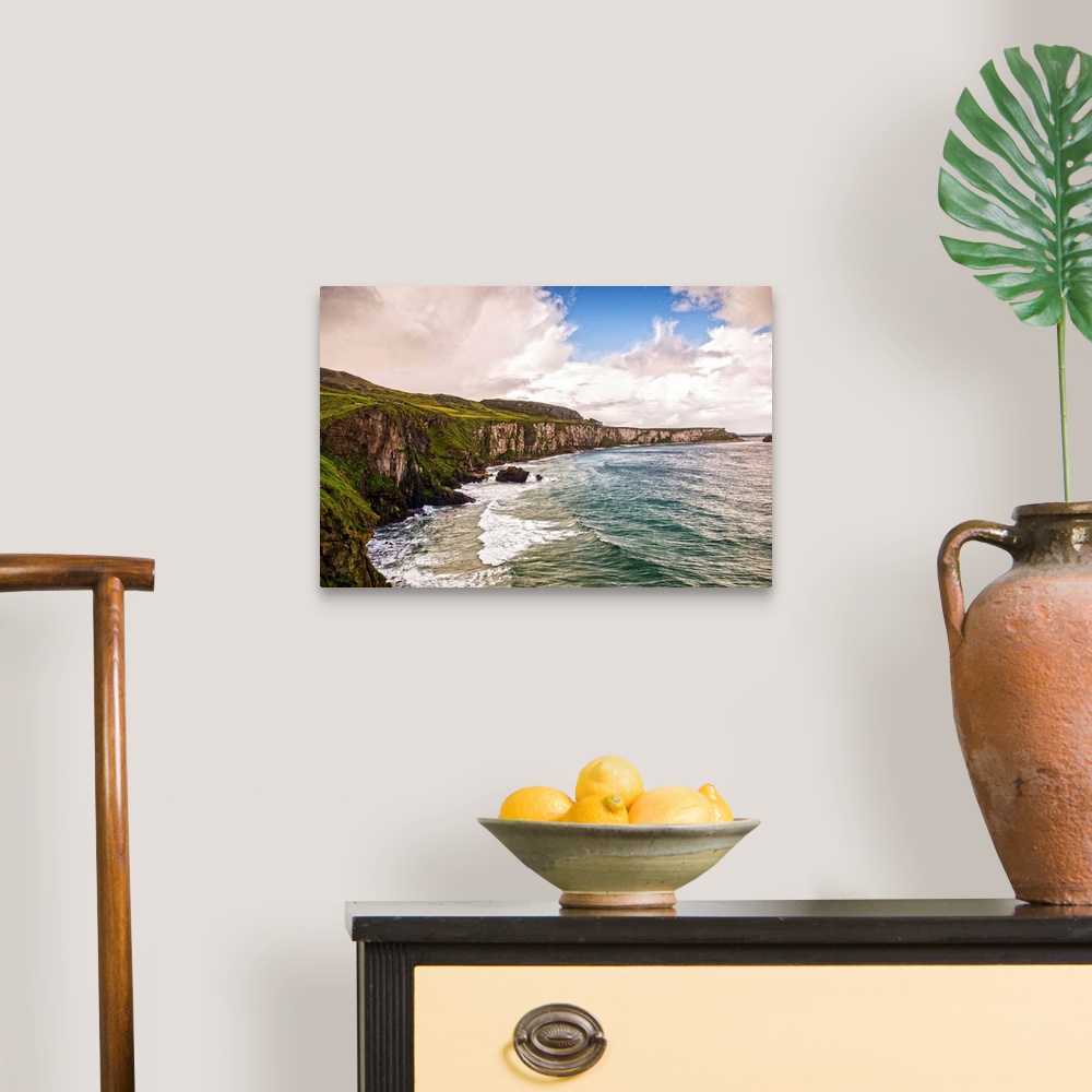 A traditional room featuring Landscape photograph of the picturesque Cliffs of Moher with a cloudy sky above, located at the s...