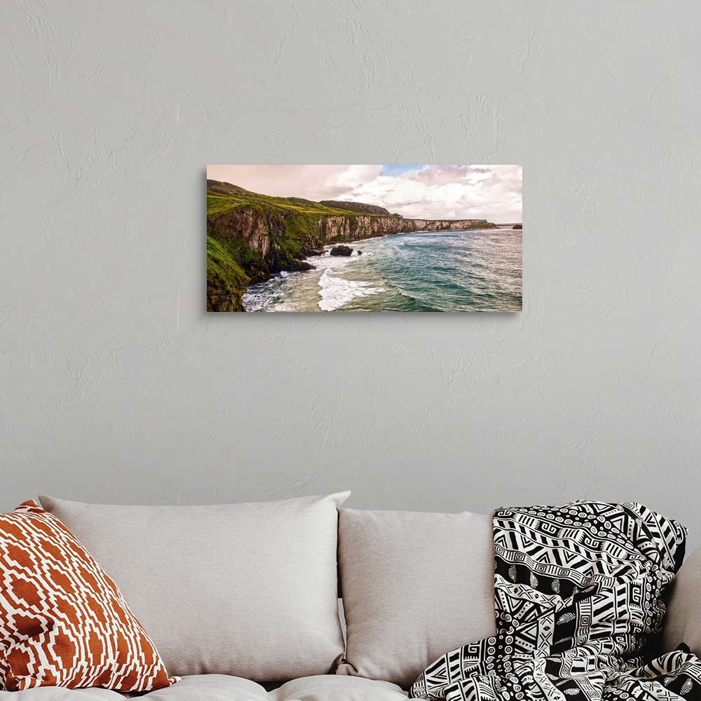 A bohemian room featuring Panoramic photograph of the picturesque Cliffs of Moher with a cloudy sky above, located at the s...