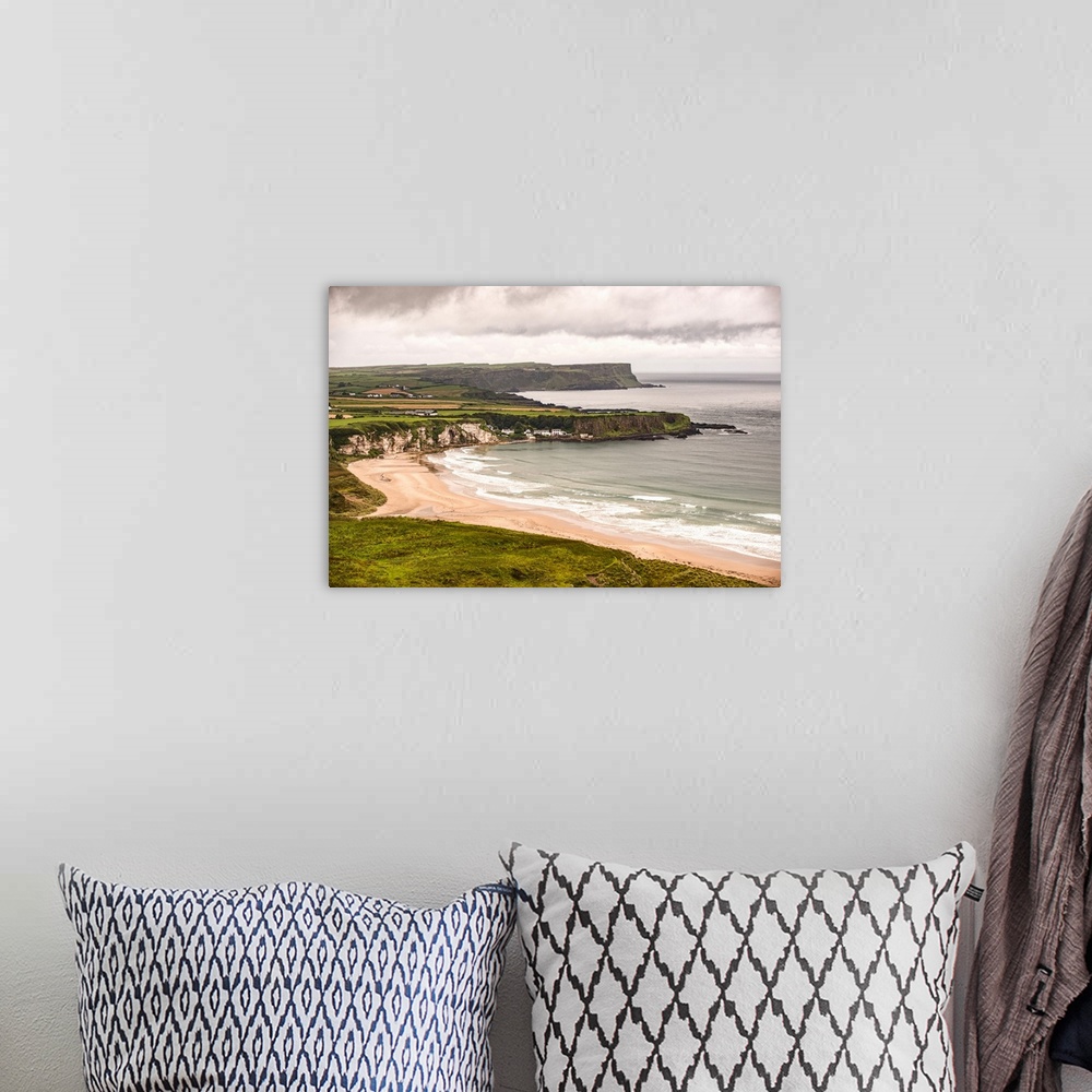 A bohemian room featuring Landscape photograph of an Irish coastline with dramatic clouds above, County Antrim, Ireland.