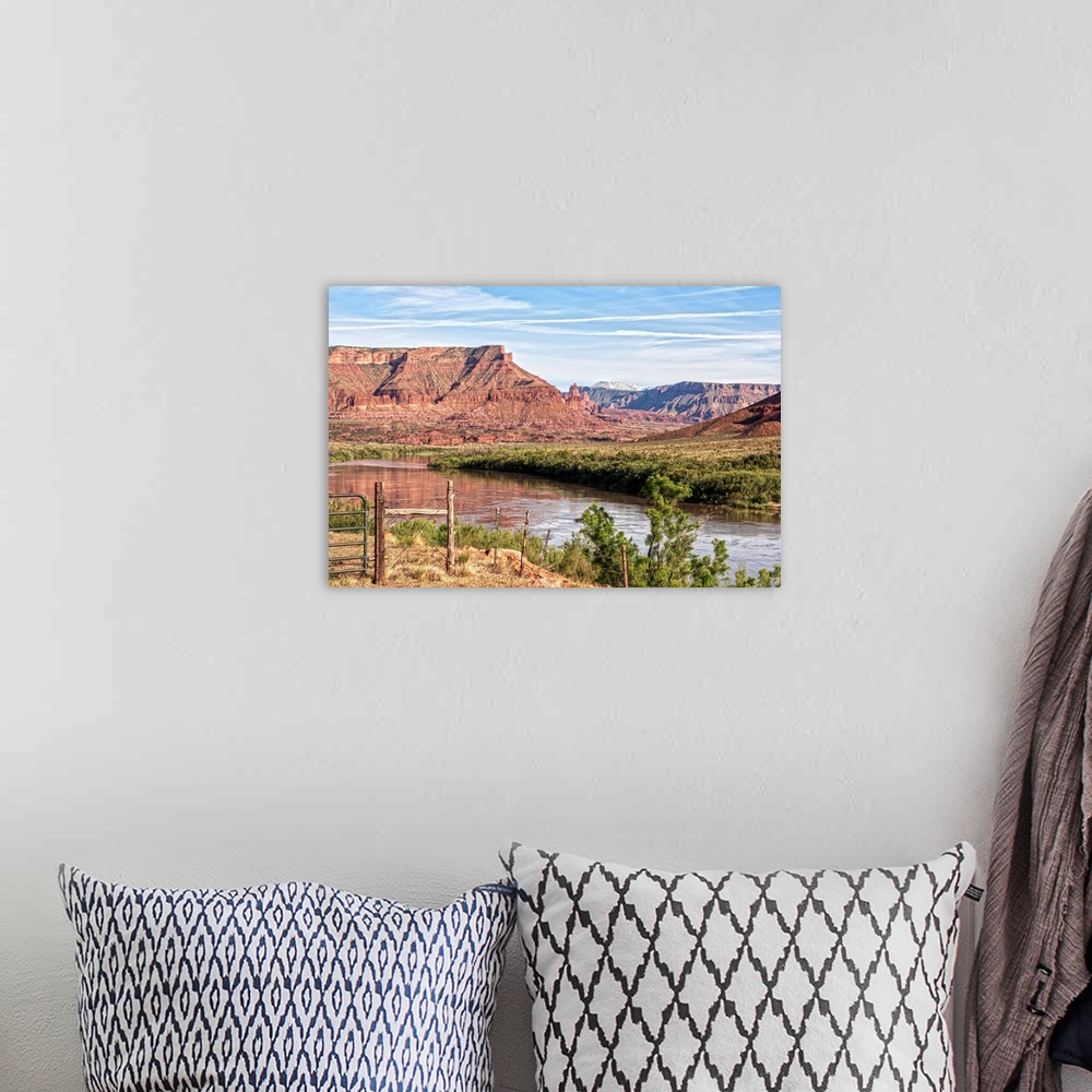 A bohemian room featuring The Colorado river running past the sandstone cliffs of the Red Rock Canyon, Arches National Park...