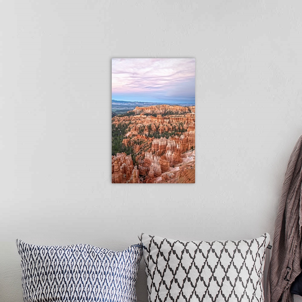 A bohemian room featuring Striped orange and white hoodoos and green pine trees under a pastel colored sky in Bryce Canyon ...