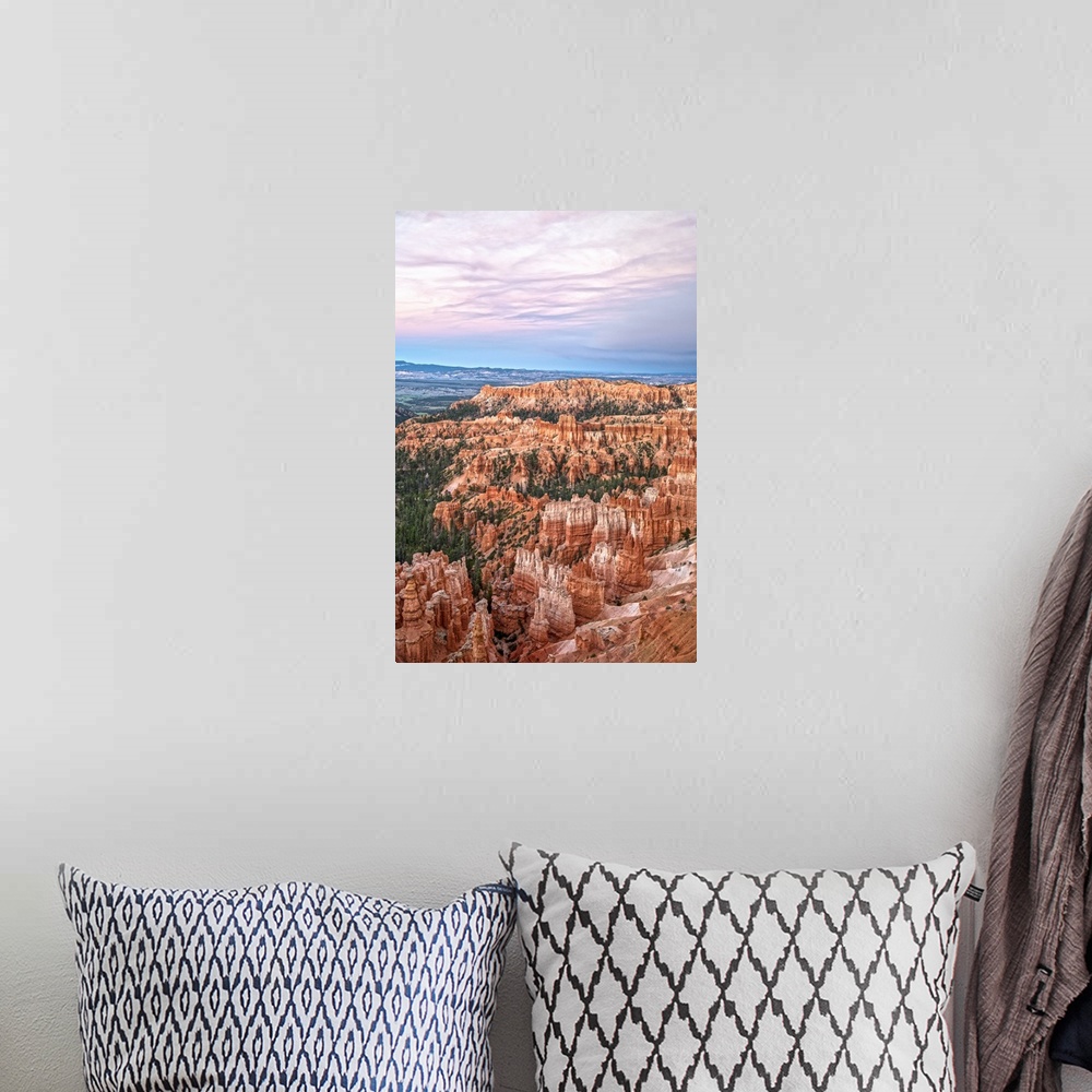 A bohemian room featuring Striped orange and white hoodoos and green pine trees under a pastel colored sky in Bryce Canyon ...