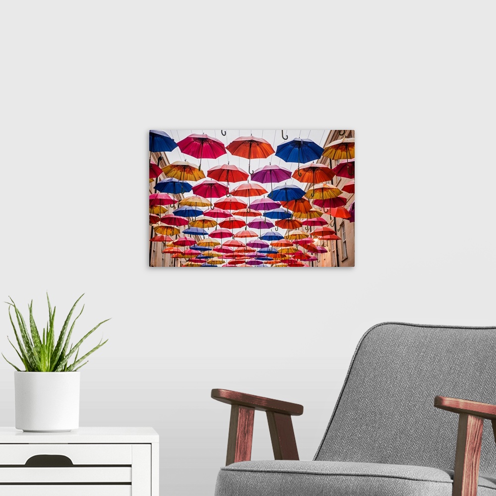 A modern room featuring Horizontal photograph of the colorful umbrellas hanging in Southgate Shopping Centre in Bath, Eng...