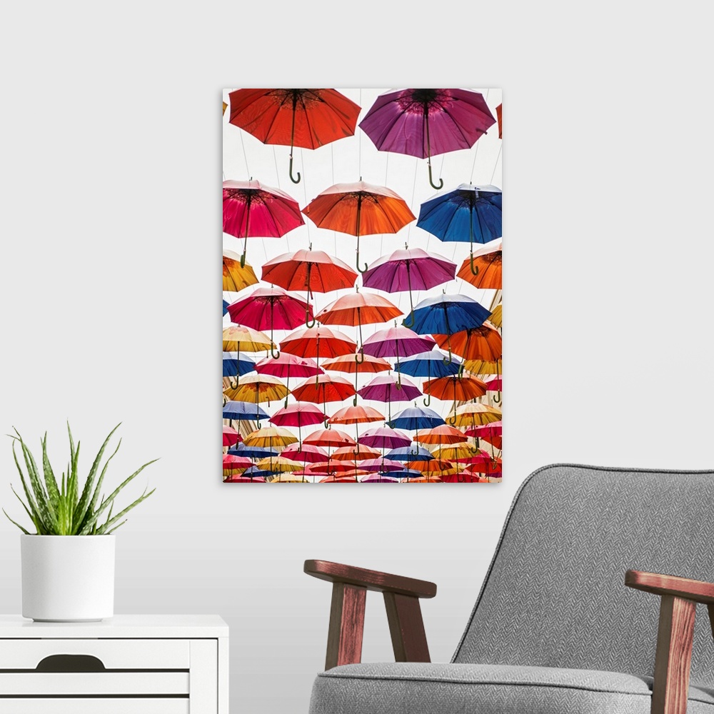 A modern room featuring Vertical photograph of the colorful umbrellas hanging in Southgate Shopping Centre in Bath, Engla...