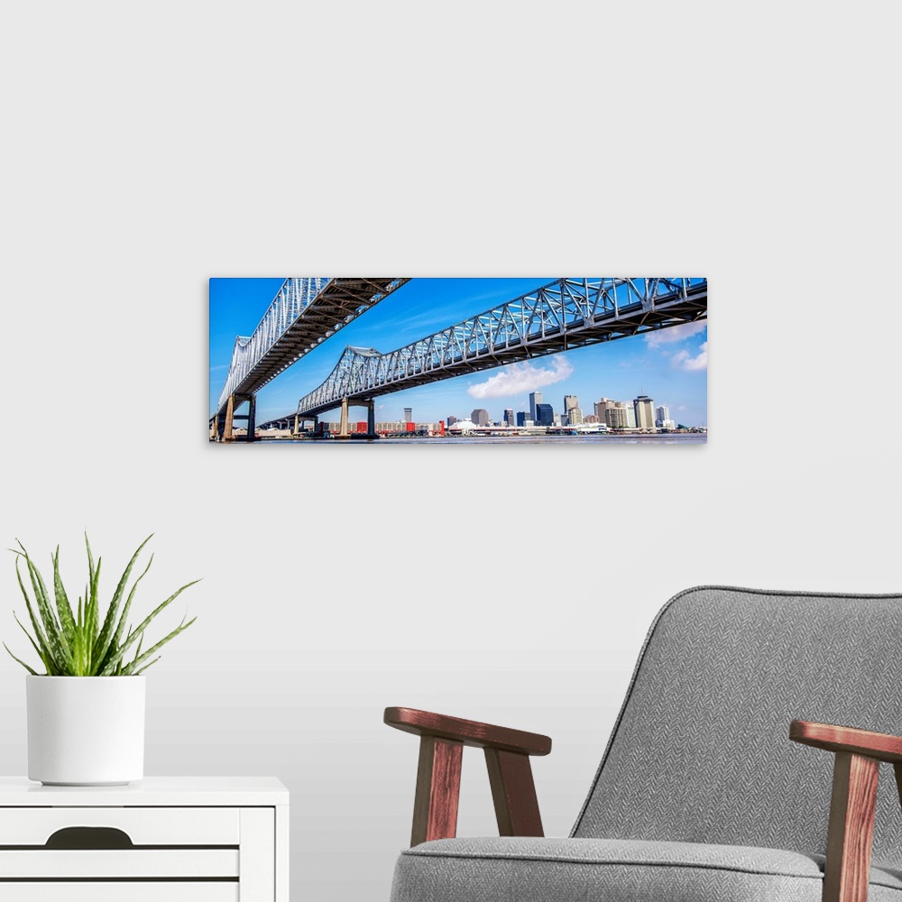 A modern room featuring Panoramic photograph of the Crescent City Connection, formerly the Greater New Orleans Bridge, tw...