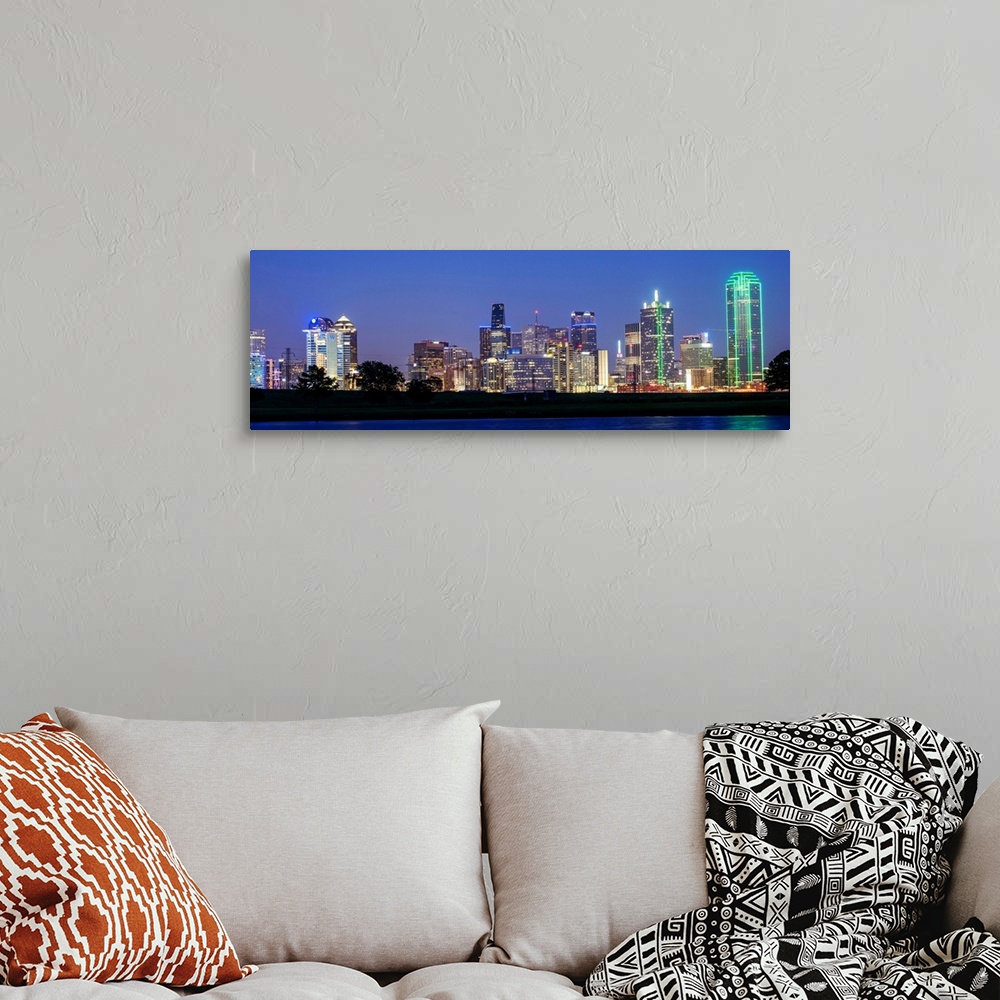 A bohemian room featuring The city skyline of Dallas at night.