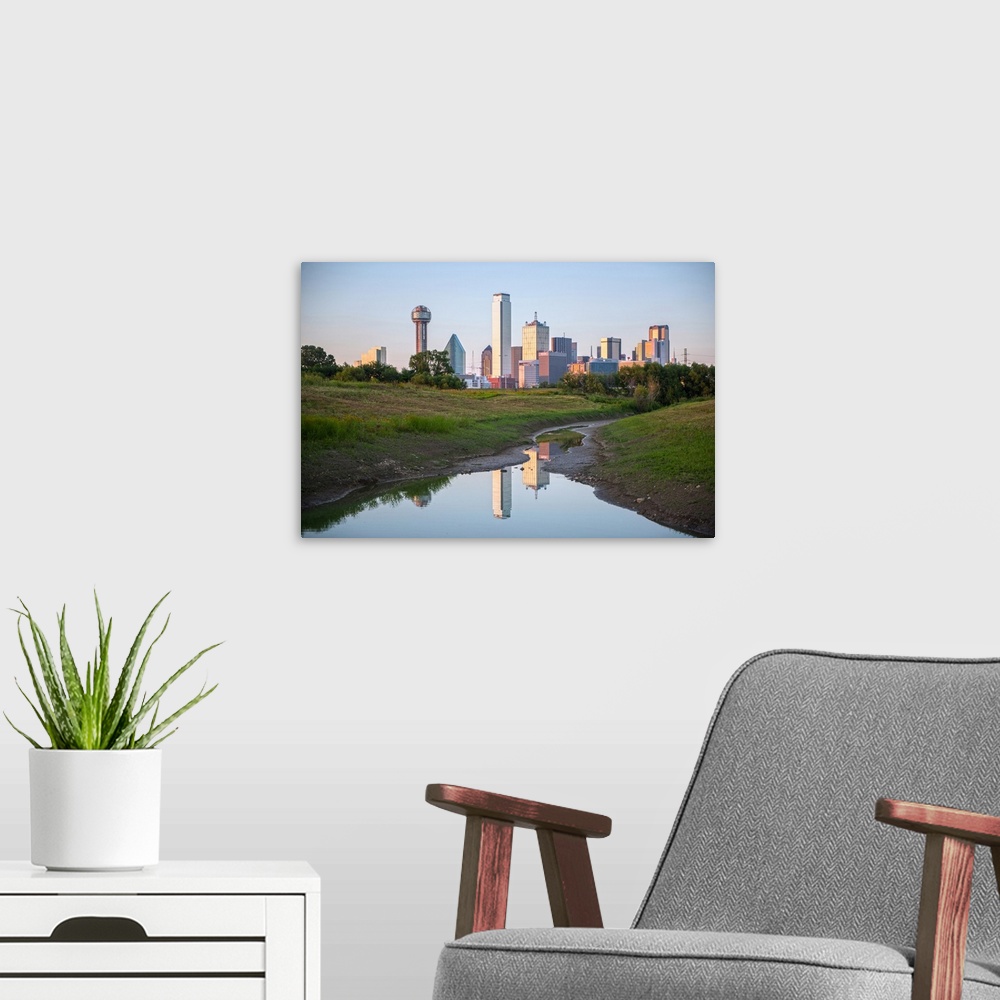A modern room featuring A creek in the foreground of the Dallas Texas skyline.