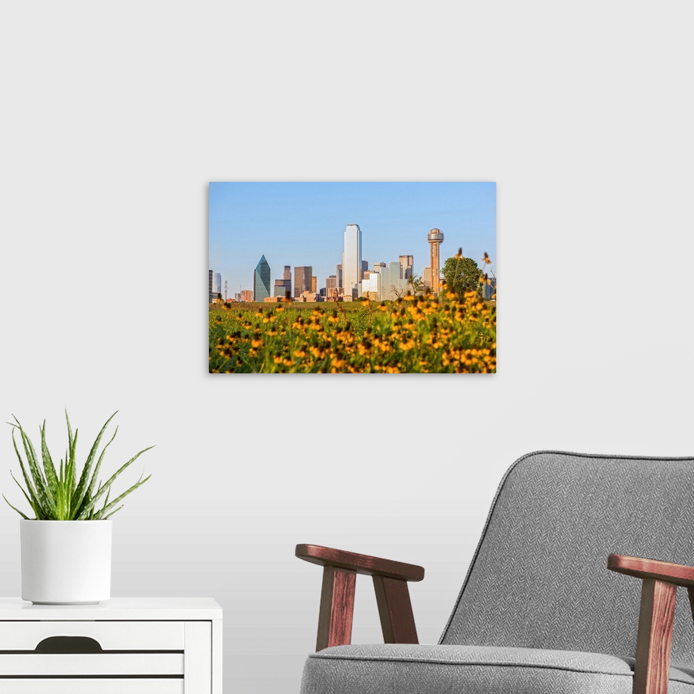 A modern room featuring A field of wild flowers in the foreground of the Dallas Texas skyline.