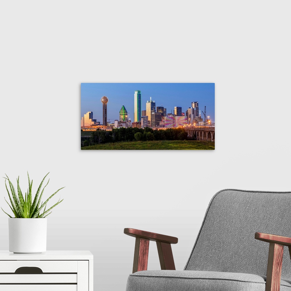 A modern room featuring A horizontal image of  the Dallas, Texas city skyline at sunset.