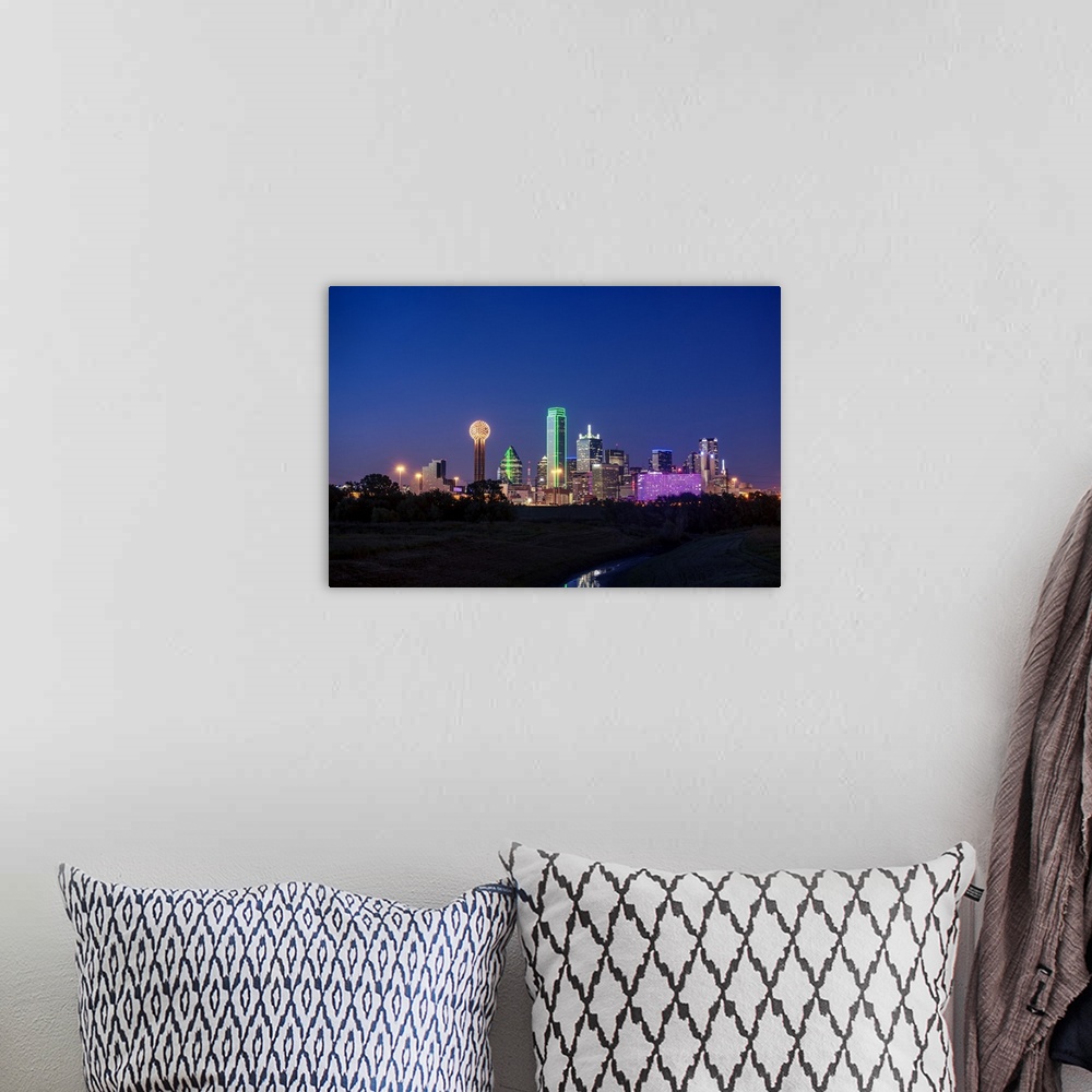 A bohemian room featuring A horizontal image of the Dallas, Texas city skyline at sunset