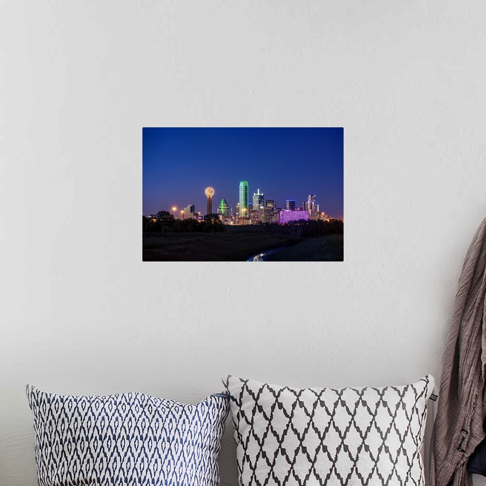 A bohemian room featuring A horizontal image of the Dallas, Texas city skyline at sunset