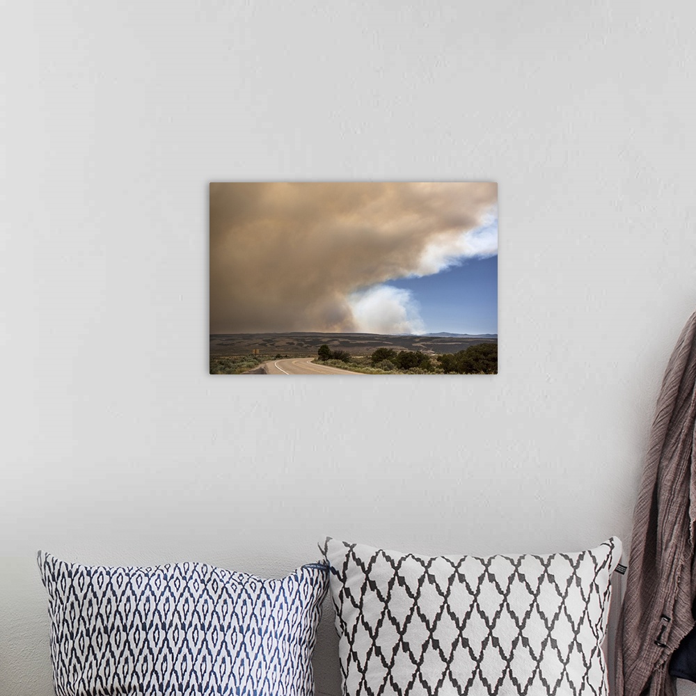 A bohemian room featuring Massive billowing smoke clouds from the Brian Head forest fire in the sky over the Utah landscape.