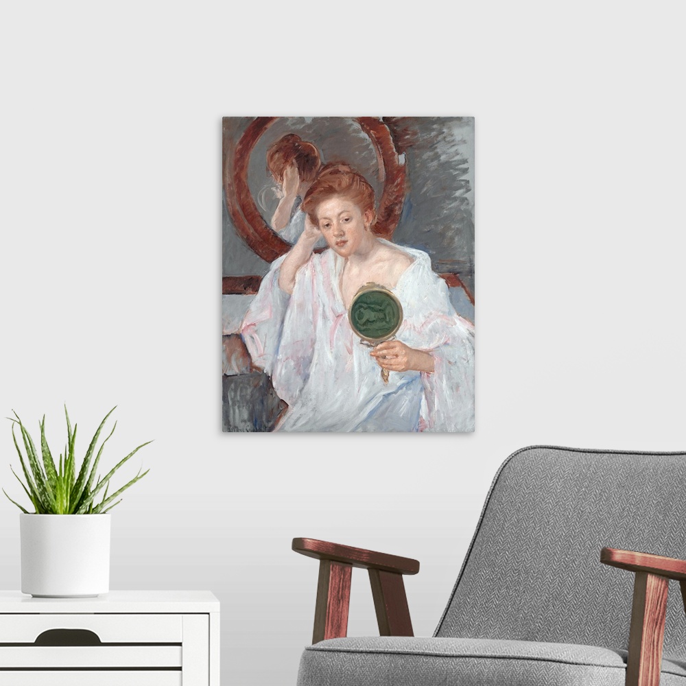 A modern room featuring Holding a hand mirror backed with green moire, a pretty auburn-haired young woman-apparently a pr...