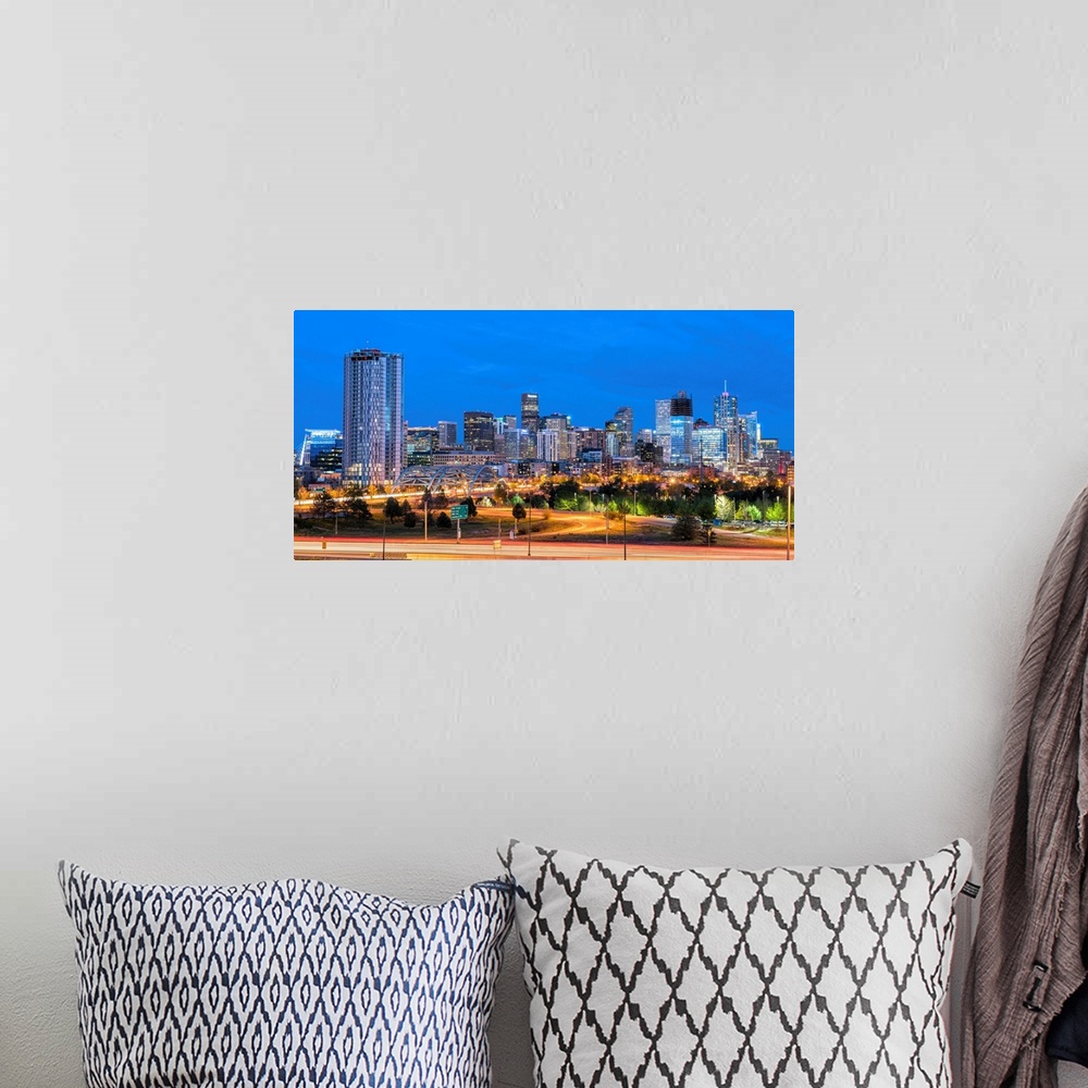 A bohemian room featuring Photograph of the Denver, CO skyline at dusk with warm light trails on the highway from passing c...