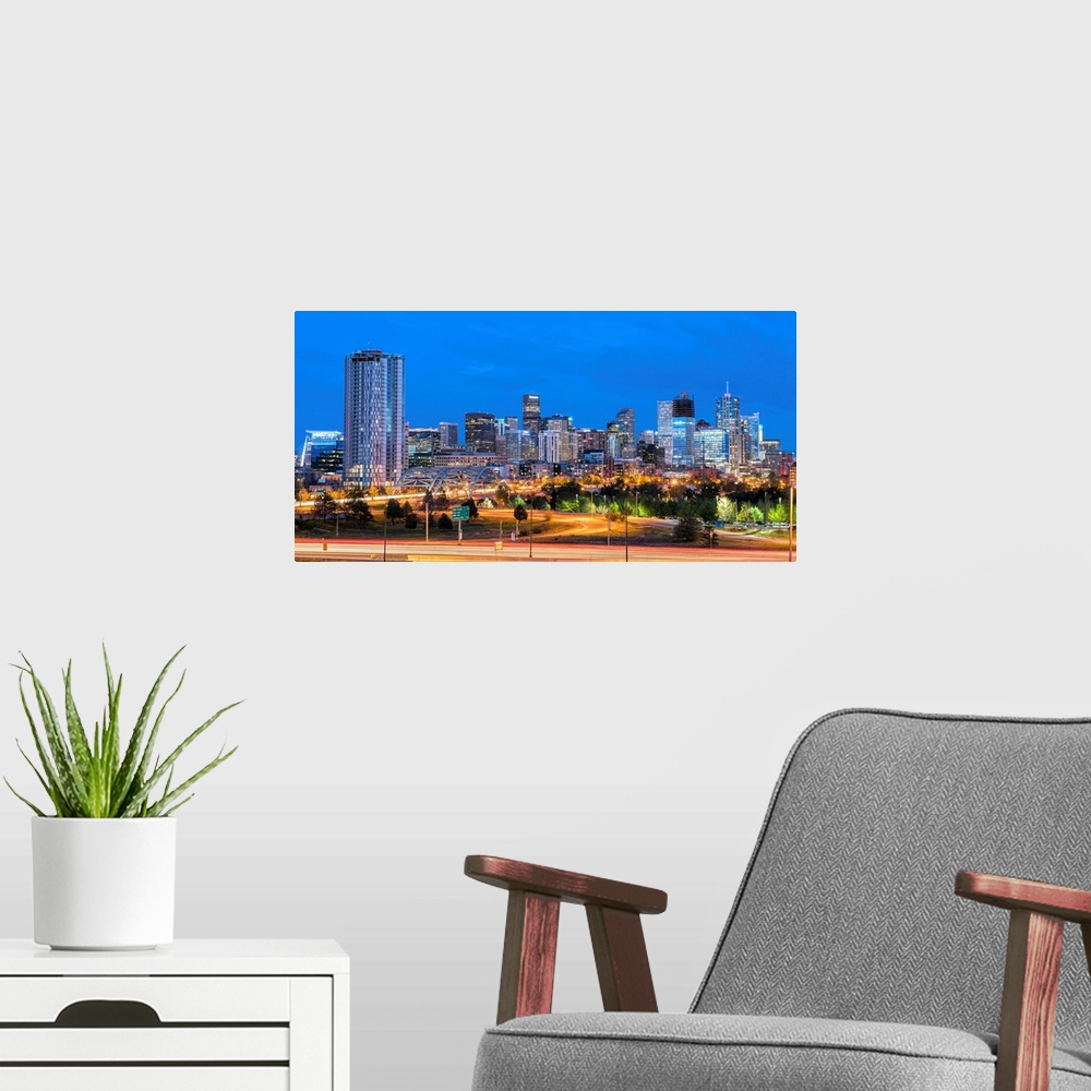 A modern room featuring Photograph of the Denver, CO skyline at dusk with warm light trails on the highway from passing c...