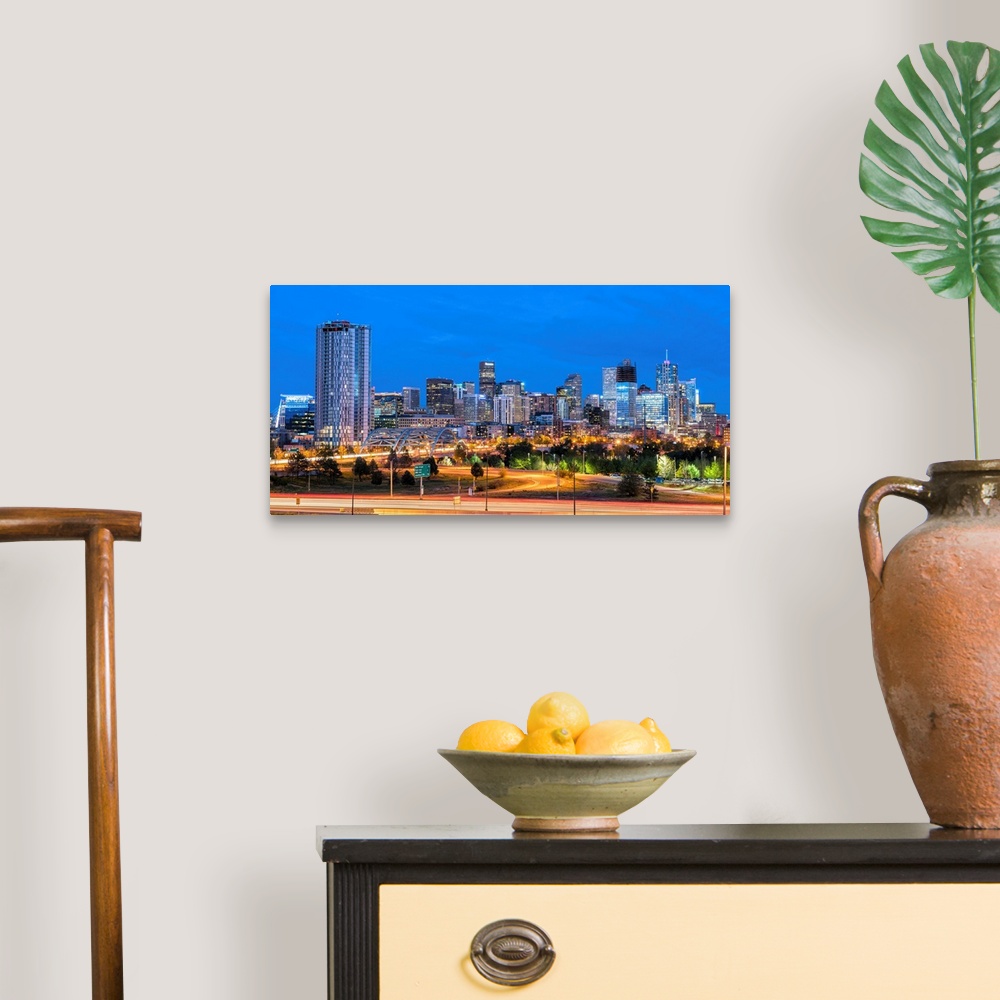 A traditional room featuring Photograph of the Denver, CO skyline at dusk with warm light trails on the highway from passing c...