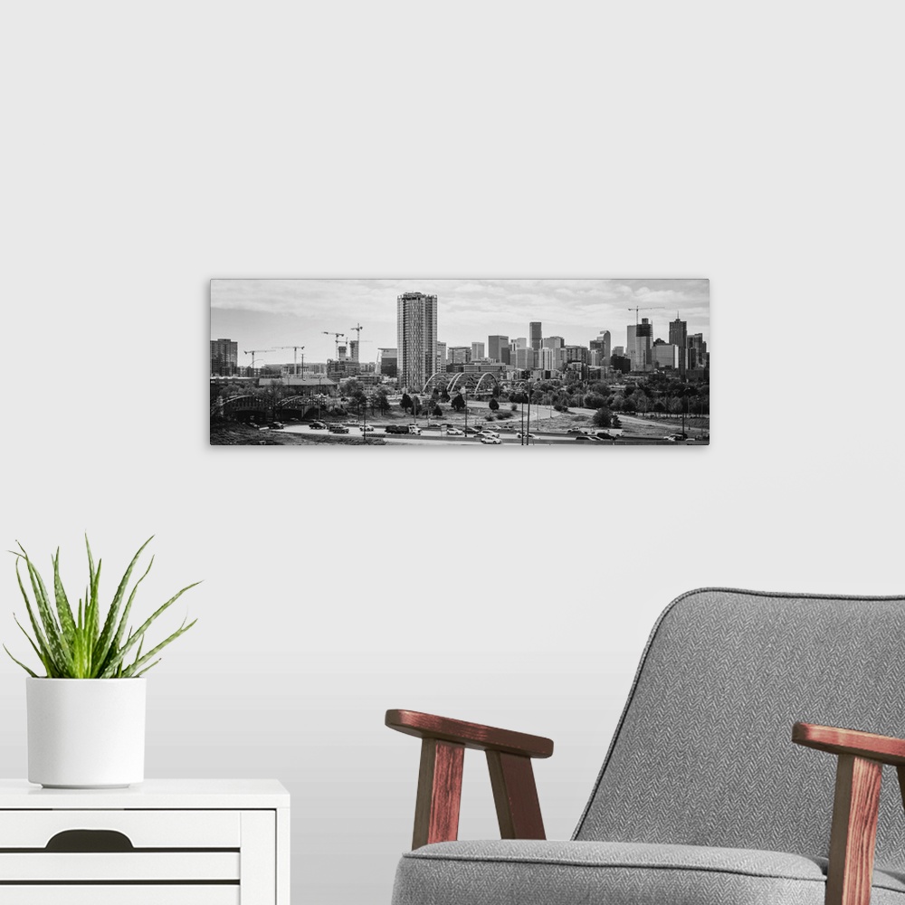 A modern room featuring Photograph of the Denver, Colorado skyline with cloudy skies above.