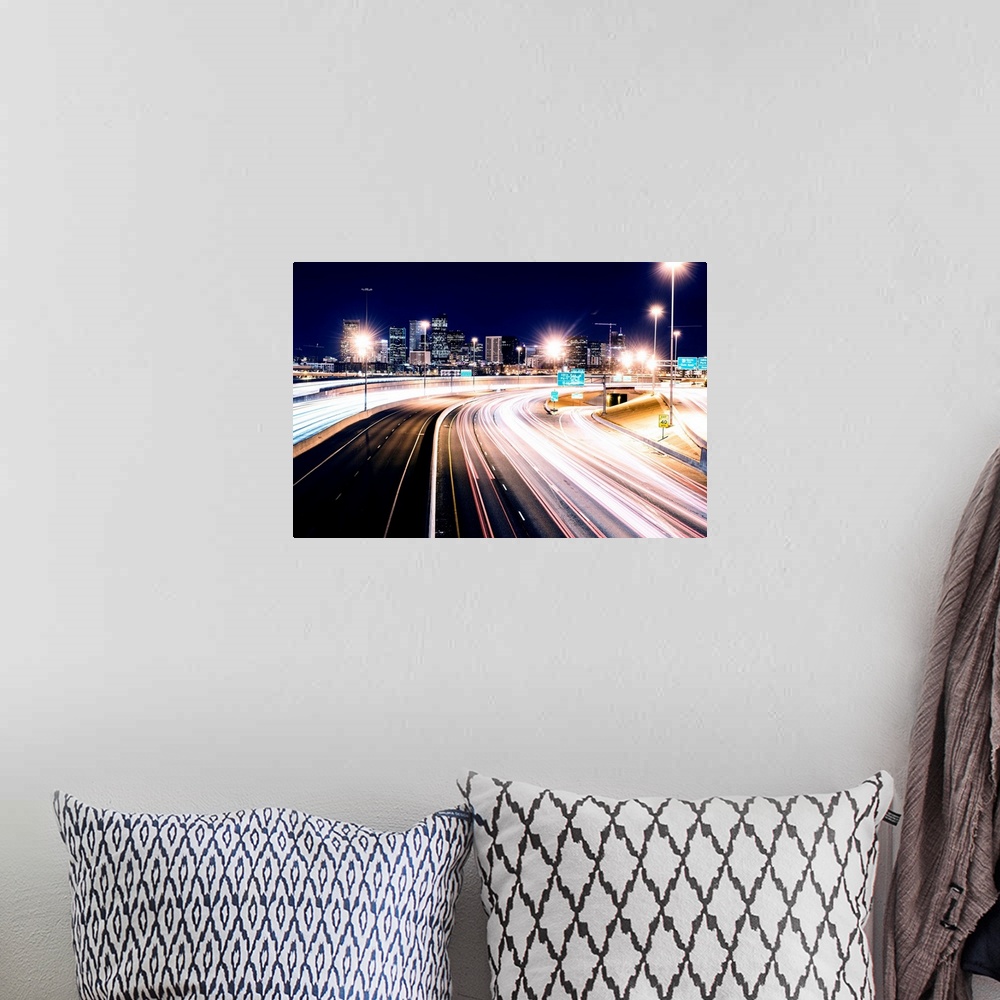 A bohemian room featuring Photo of light trails against Denver's night skyline.