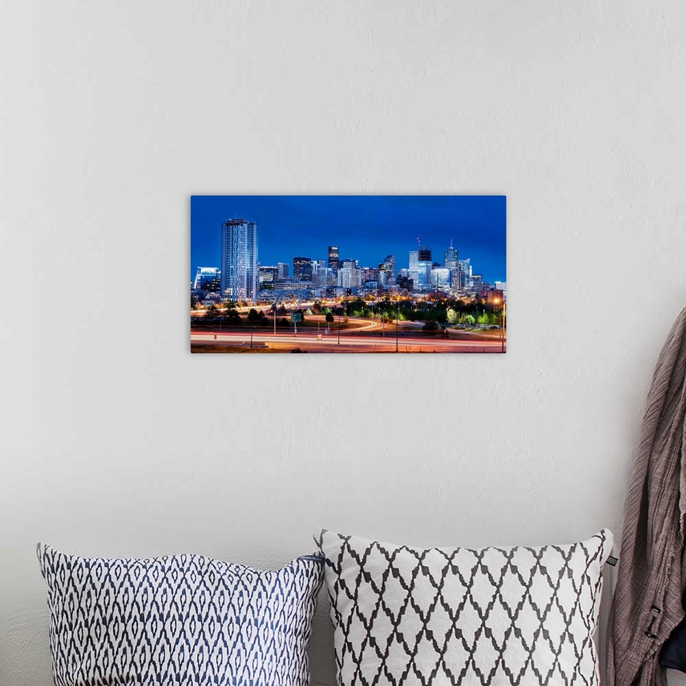 A bohemian room featuring Photo of Denver's skyline at night with light trails.