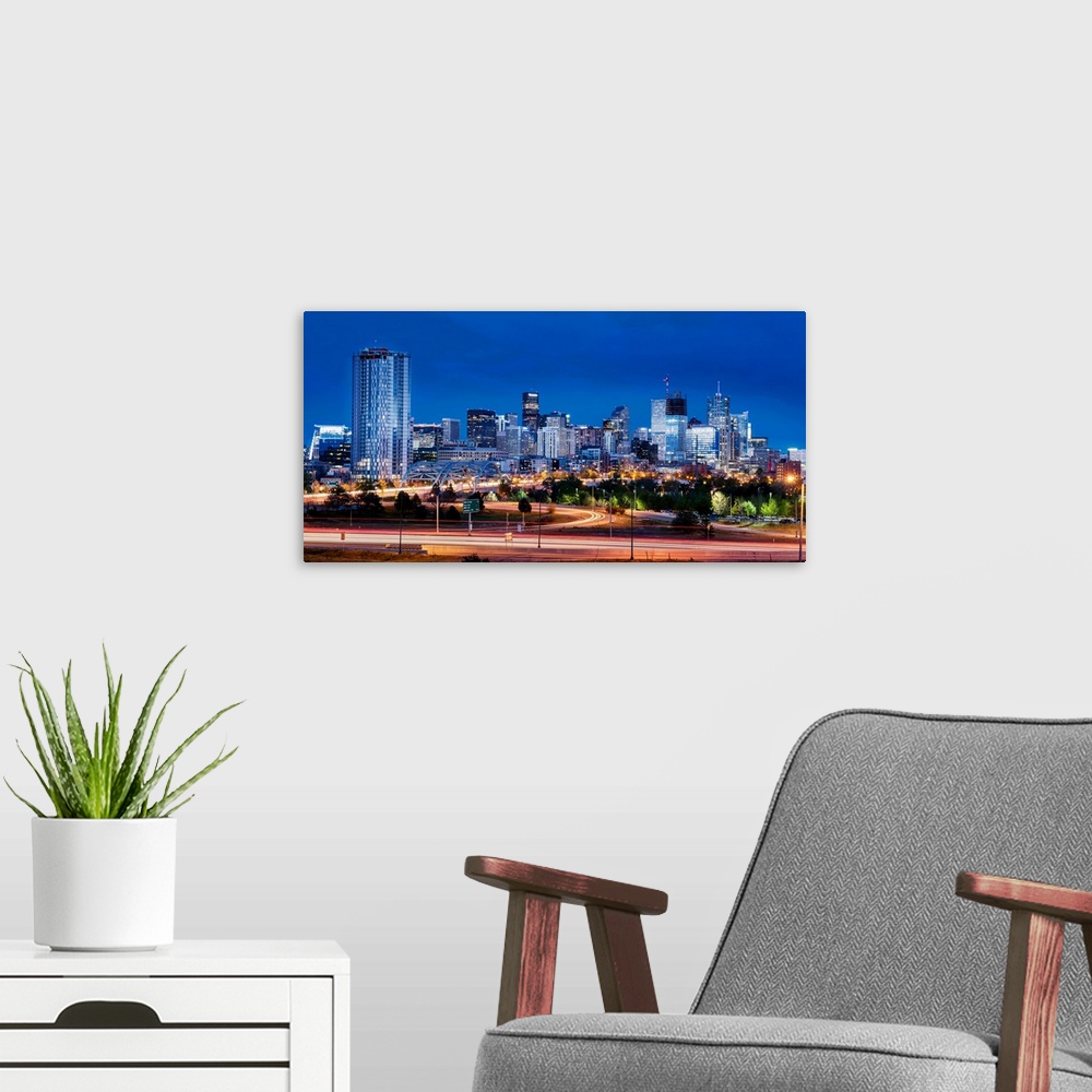 A modern room featuring Photo of Denver's skyline at night with light trails.