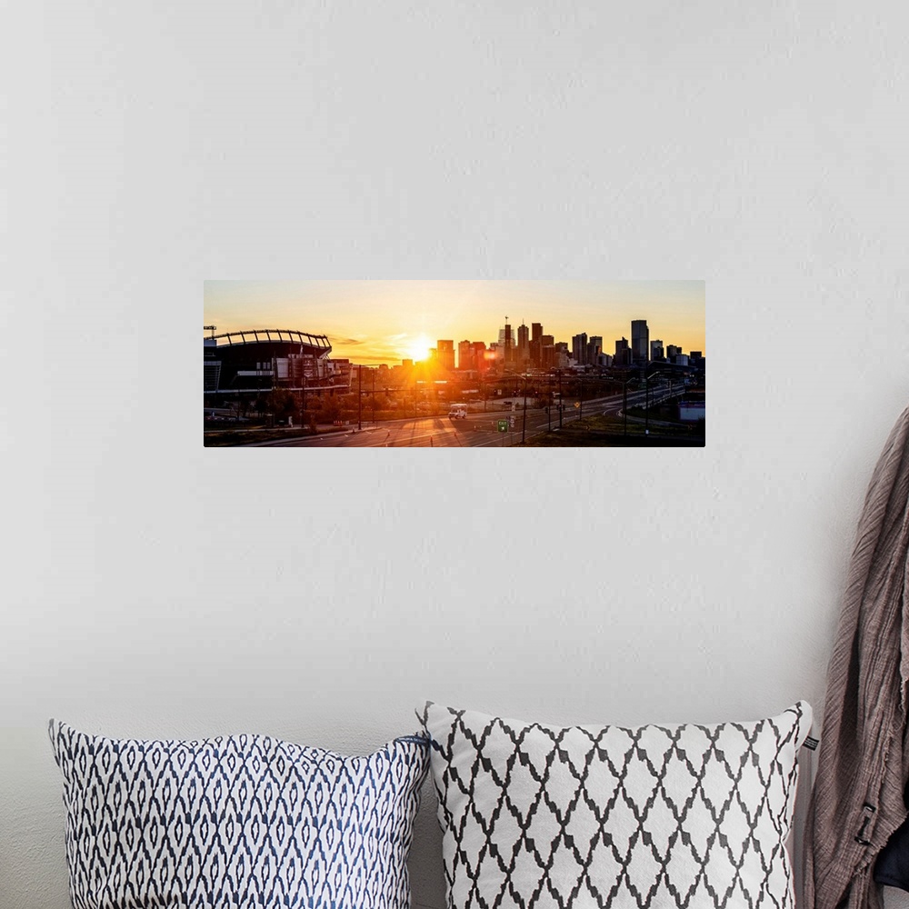 A bohemian room featuring Panoramic photo of a Denver skyline against a breathtaking sunrise.