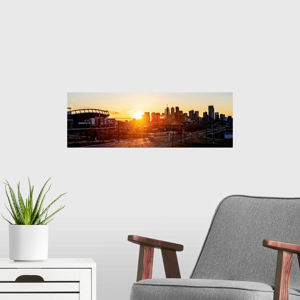 A modern room featuring Panoramic photo of a Denver skyline against a breathtaking sunrise.