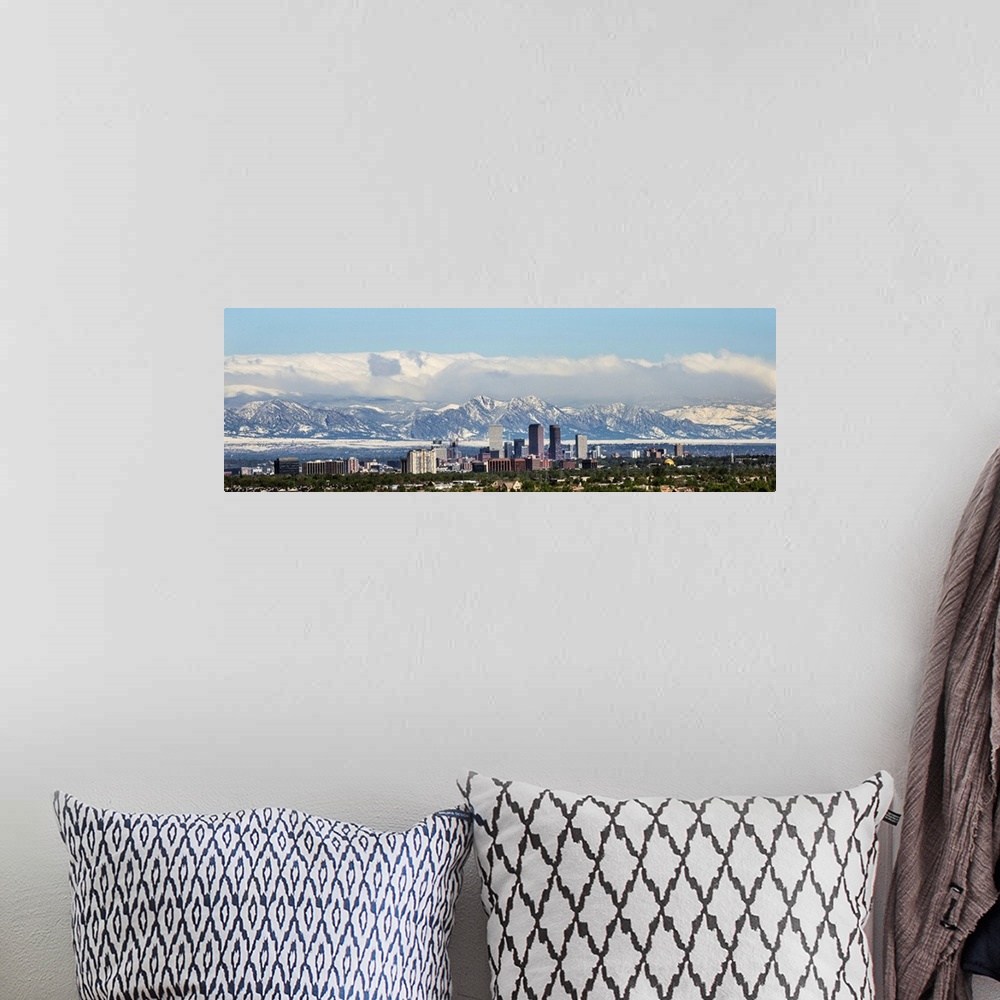 A bohemian room featuring Panoramic photo of a Denver skyline against a backdrop of the Rocky Mountains.
