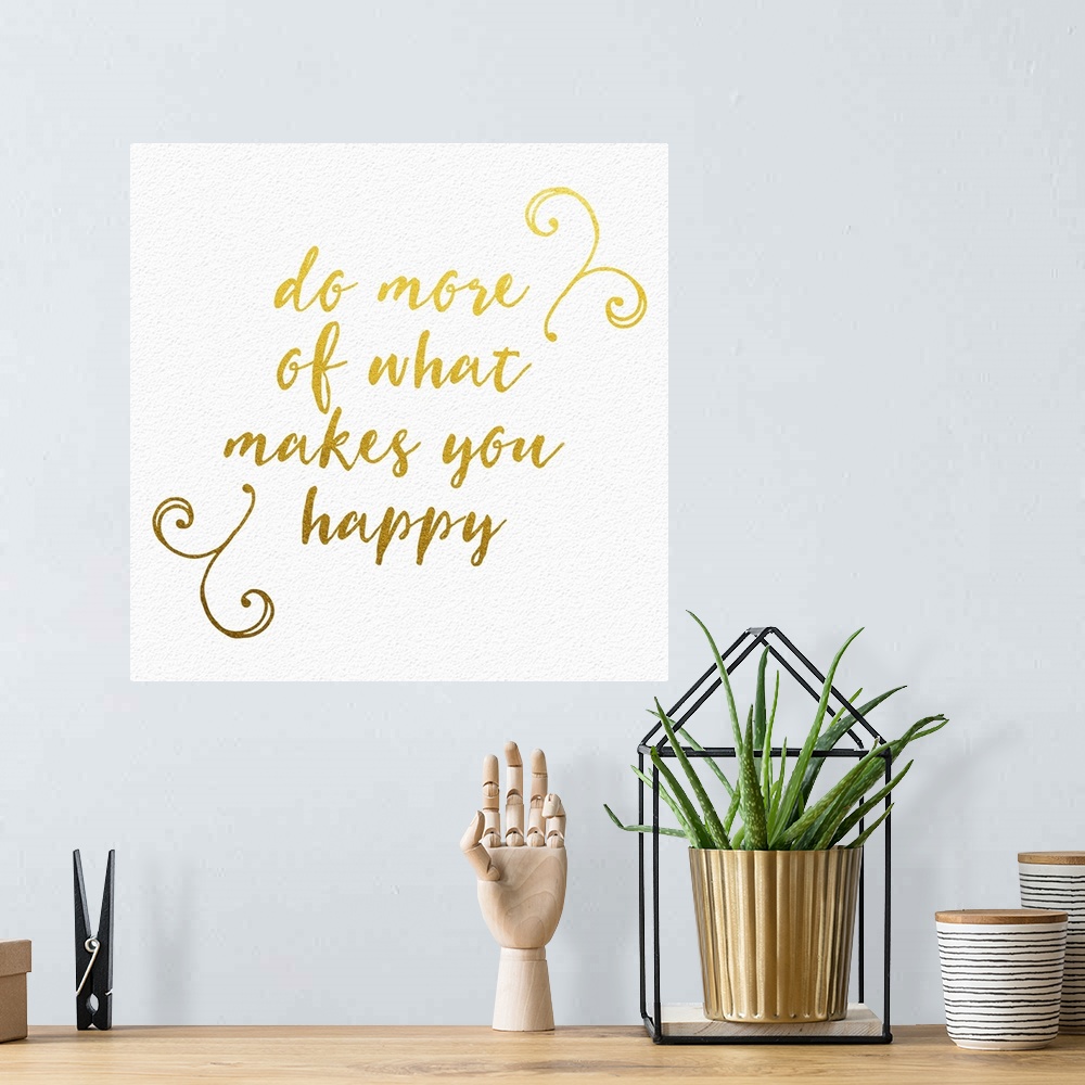 A bohemian room featuring "Do more of what makes you happy" handwritten in gold with small flourishes.