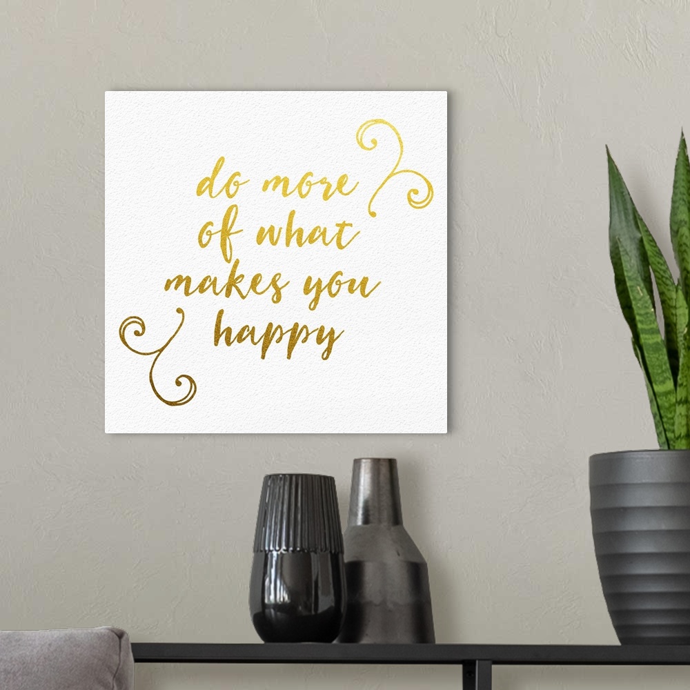 A modern room featuring "Do more of what makes you happy" handwritten in gold with small flourishes.