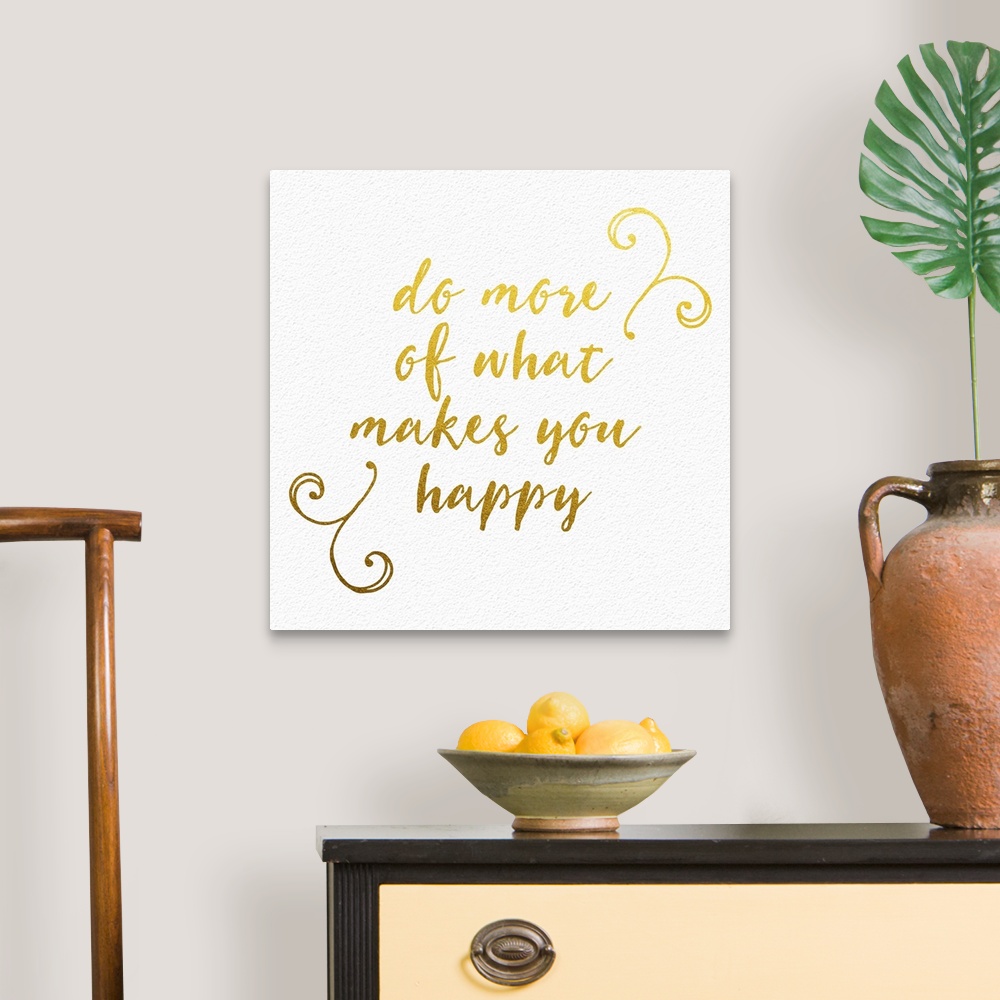 A traditional room featuring "Do more of what makes you happy" handwritten in gold with small flourishes.