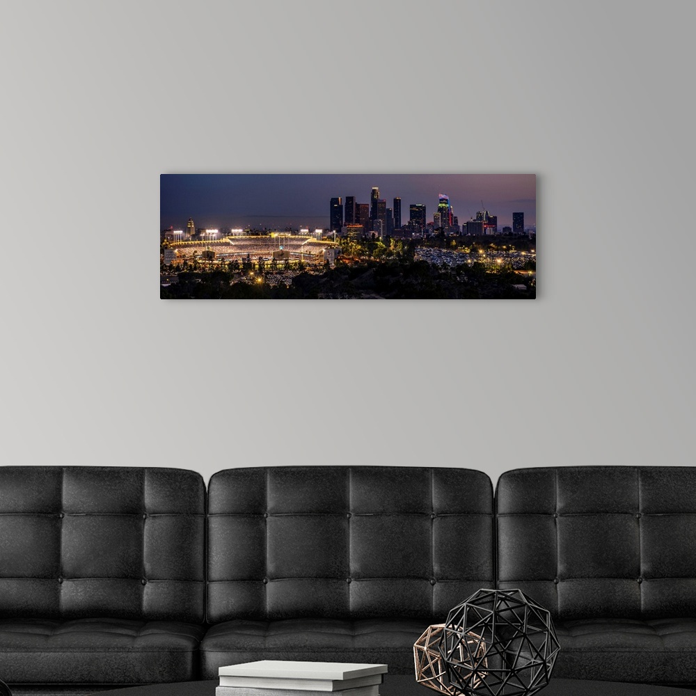 A modern room featuring Panoramic photograph of Dodger Stadium lit up on a game night with the Los Angeles skyline on the...