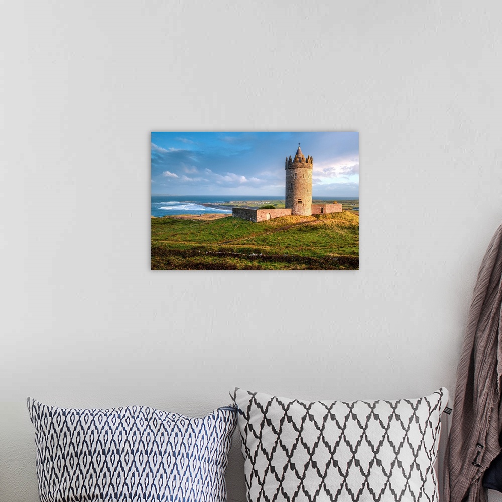 A bohemian room featuring Photograph of Doonagore Castle in Doolin in County Clare, Ireland, with a beautiful sunset.