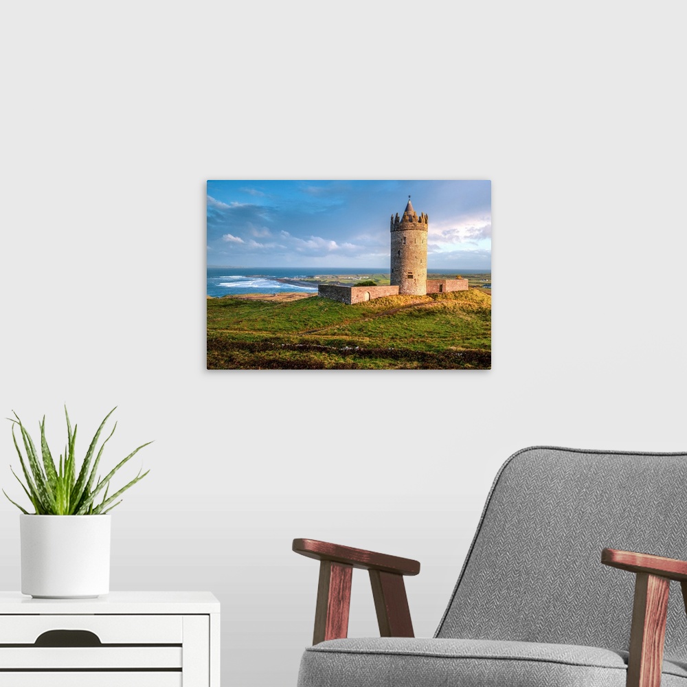 A modern room featuring Photograph of Doonagore Castle in Doolin in County Clare, Ireland, with a beautiful sunset.