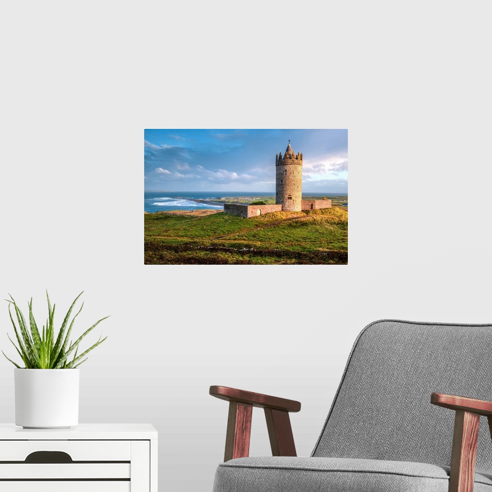 A modern room featuring Photograph of Doonagore Castle in Doolin in County Clare, Ireland, with a beautiful sunset.