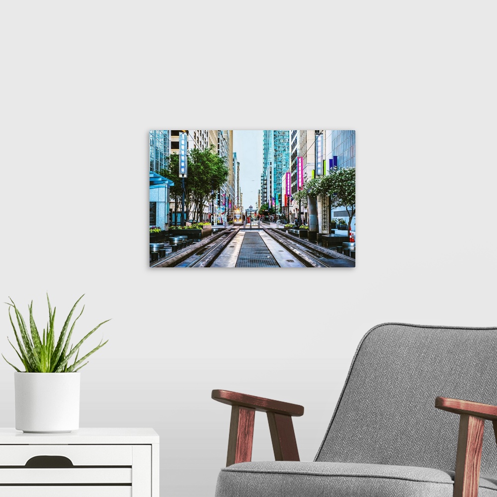 A modern room featuring Downtown photograph of Houston TX with the METRORail coming down the center.