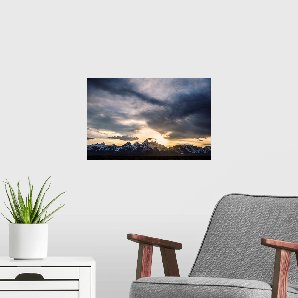 A modern room featuring View of dramatic clouds over Teton mountains in Wyoming.