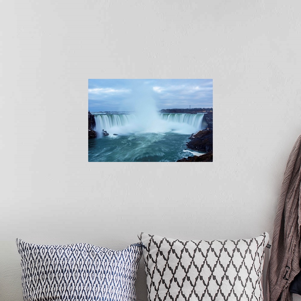 A bohemian room featuring Photo of dramatic mist from Horseshoe Falls plunges high into the air.