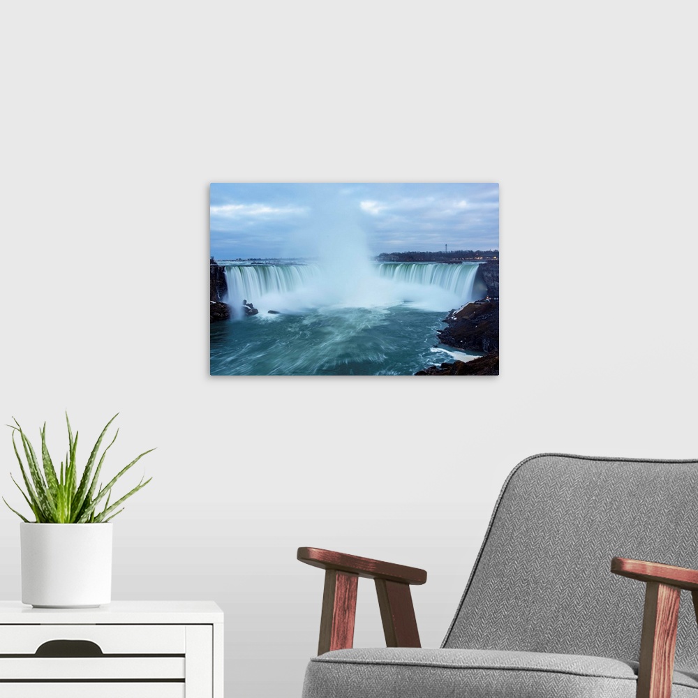 A modern room featuring Photo of dramatic mist from Horseshoe Falls plunges high into the air.