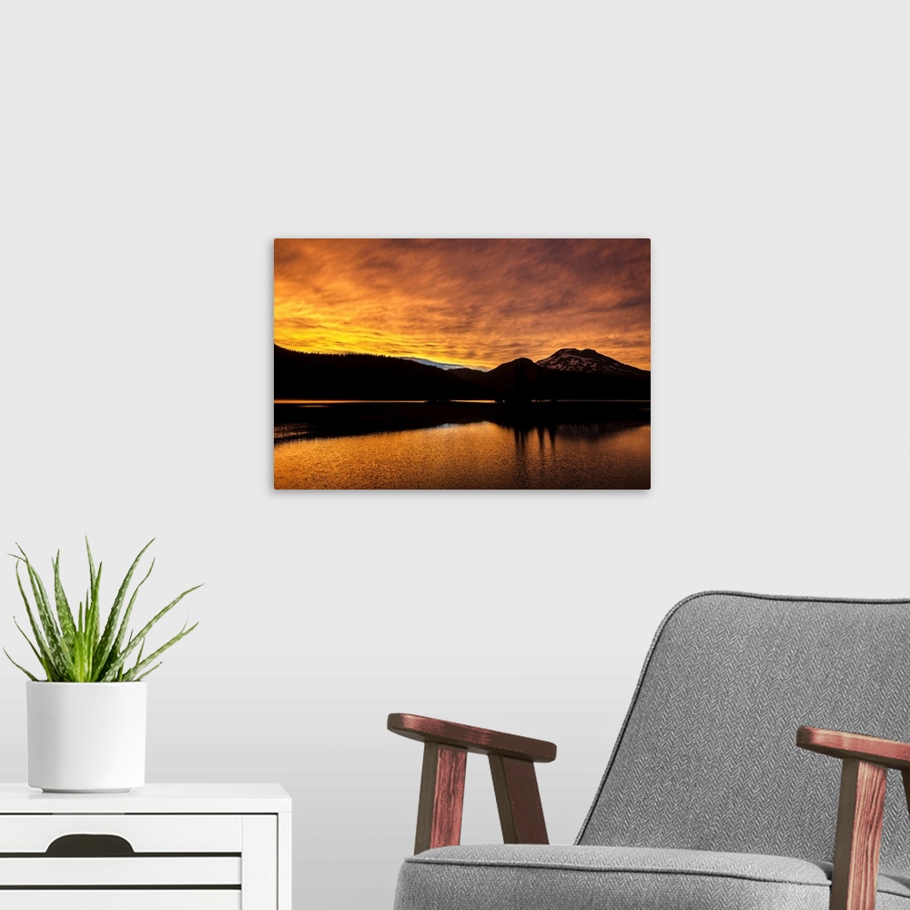 A modern room featuring View of a dramatic sunset with vibrant oranges against a silhouette of Deschutes National Forest ...